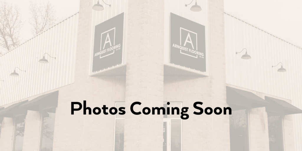 A placeholder image with the text "photos coming soon" superimposed over a grayscale photograph of a commercial building with signs that read "Church For The Harvest.