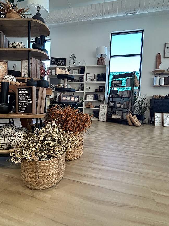 A cozy interior design shop filled with rustic home decor items, best flooring solutions, and dried flower arrangements, showcasing a warm and welcoming ambiance.