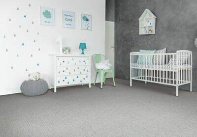 Modern and serene nursery room with a white crib, matching dresser, and a cozy Amarillo chair, adorned with whimsical wall art and a soft gray carpet.