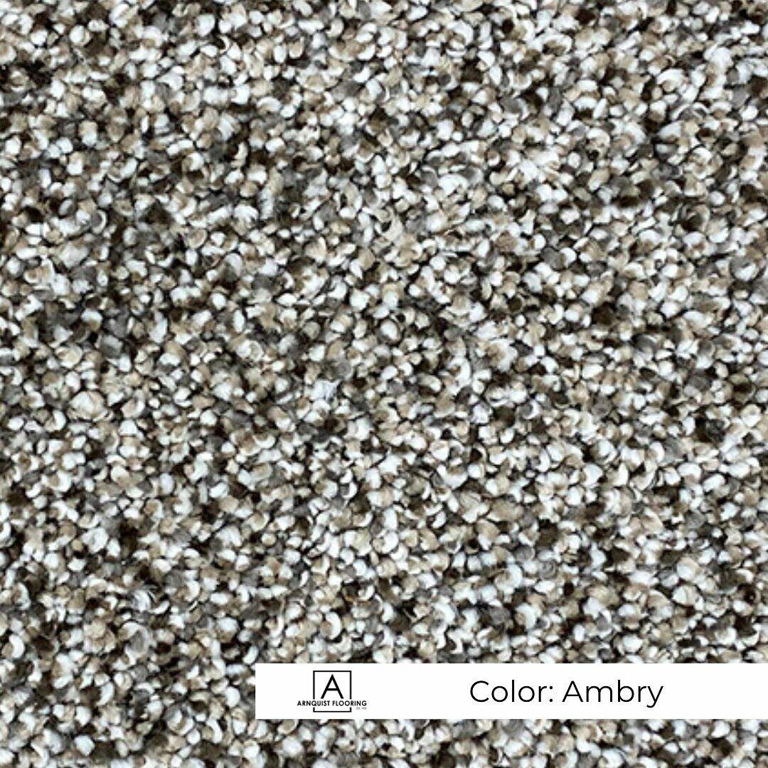 Close-up view of a textured carpet with speckled ambry coloring.