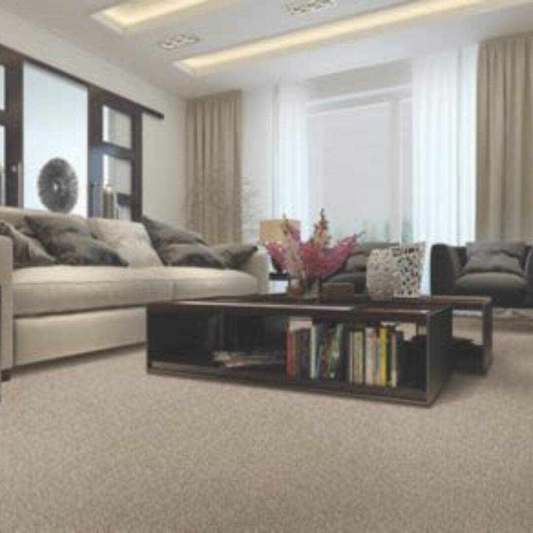A cozy and modern living room with plush seating, a sleek coffee table filled with books, and ambient lighting that creates a warm and inviting Uptown Taupe atmosphere.