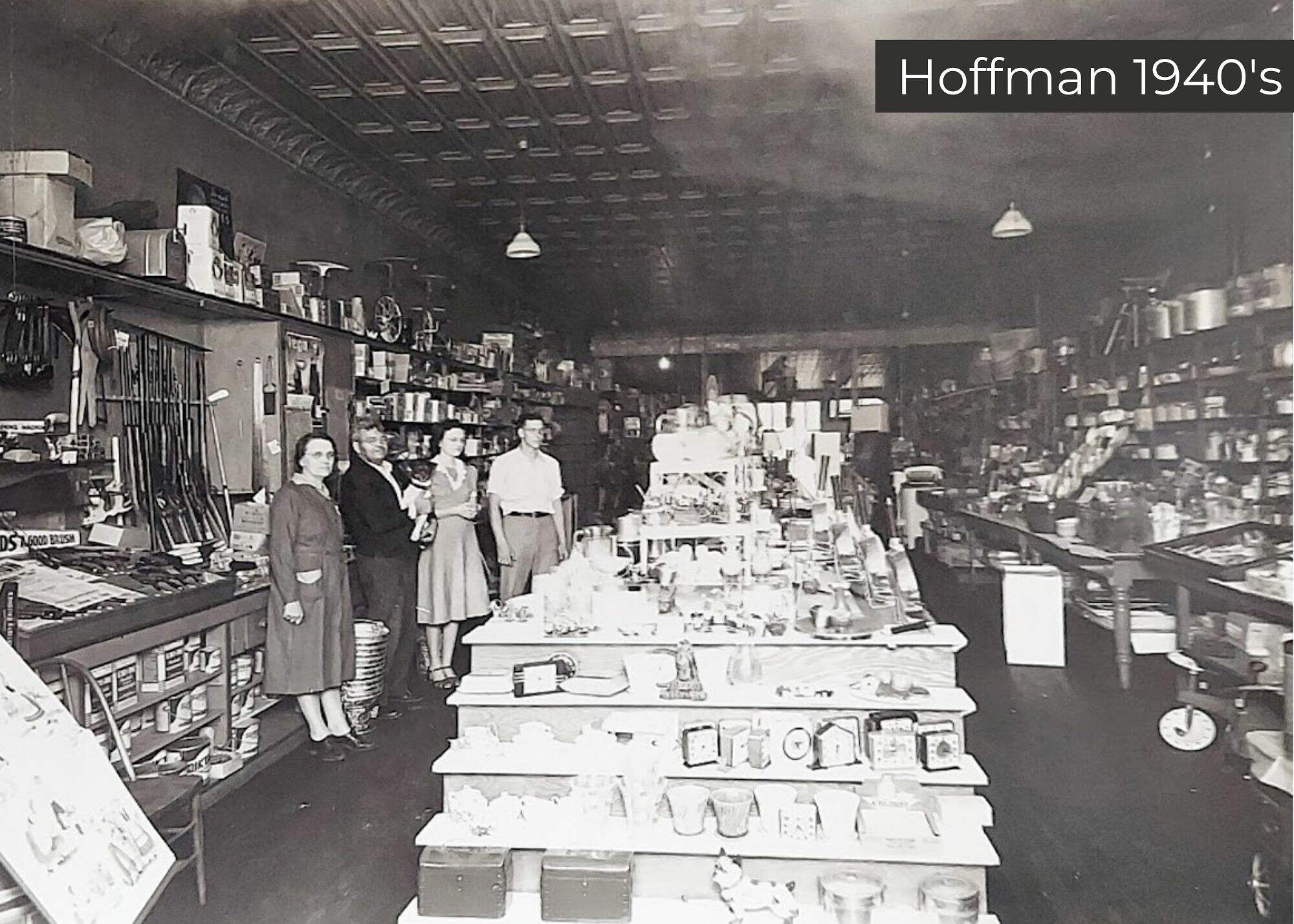A glimpse of the past: patrons and staff stand amidst the assorted wares of a bustling general store in the 1940s, where the shelves are brimming with goods from floor to ceiling.